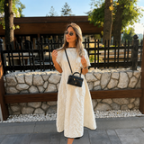 Elegantna bijela midi haljina s reljefnim cvjetnim uzorkom i crnim detaljima. - slika 2
